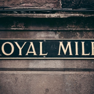 Royal Mile Road Sign in Edinburgh framed photographic print against textured stone wall.